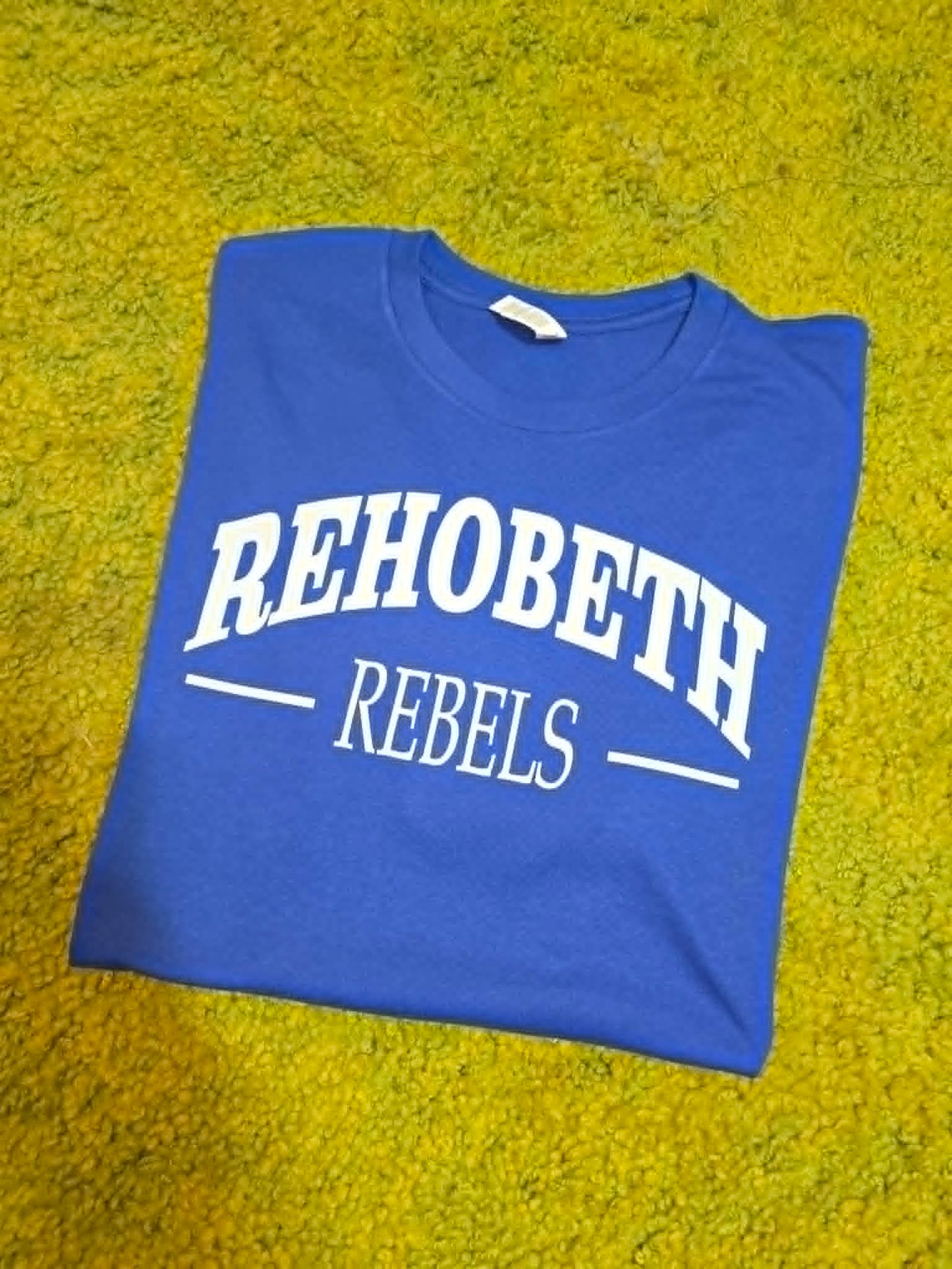 Blue Rehobeth Rebels shirt with classic white varsity lettering