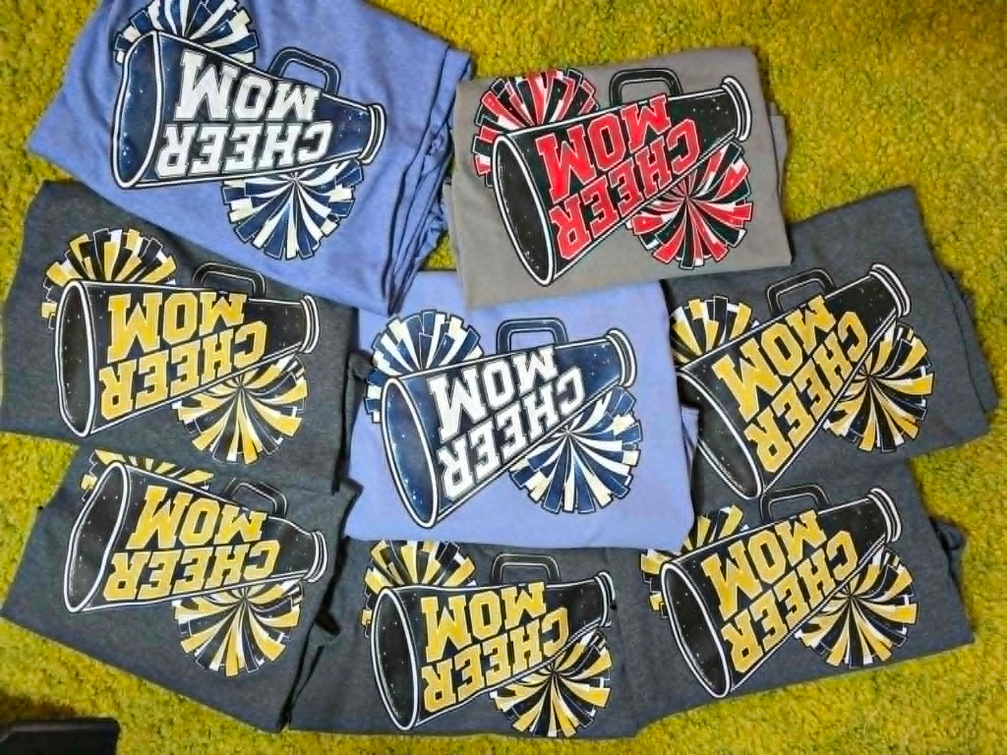 Cheer Mom shirts with megaphones and pom-poms in multiple school colors
