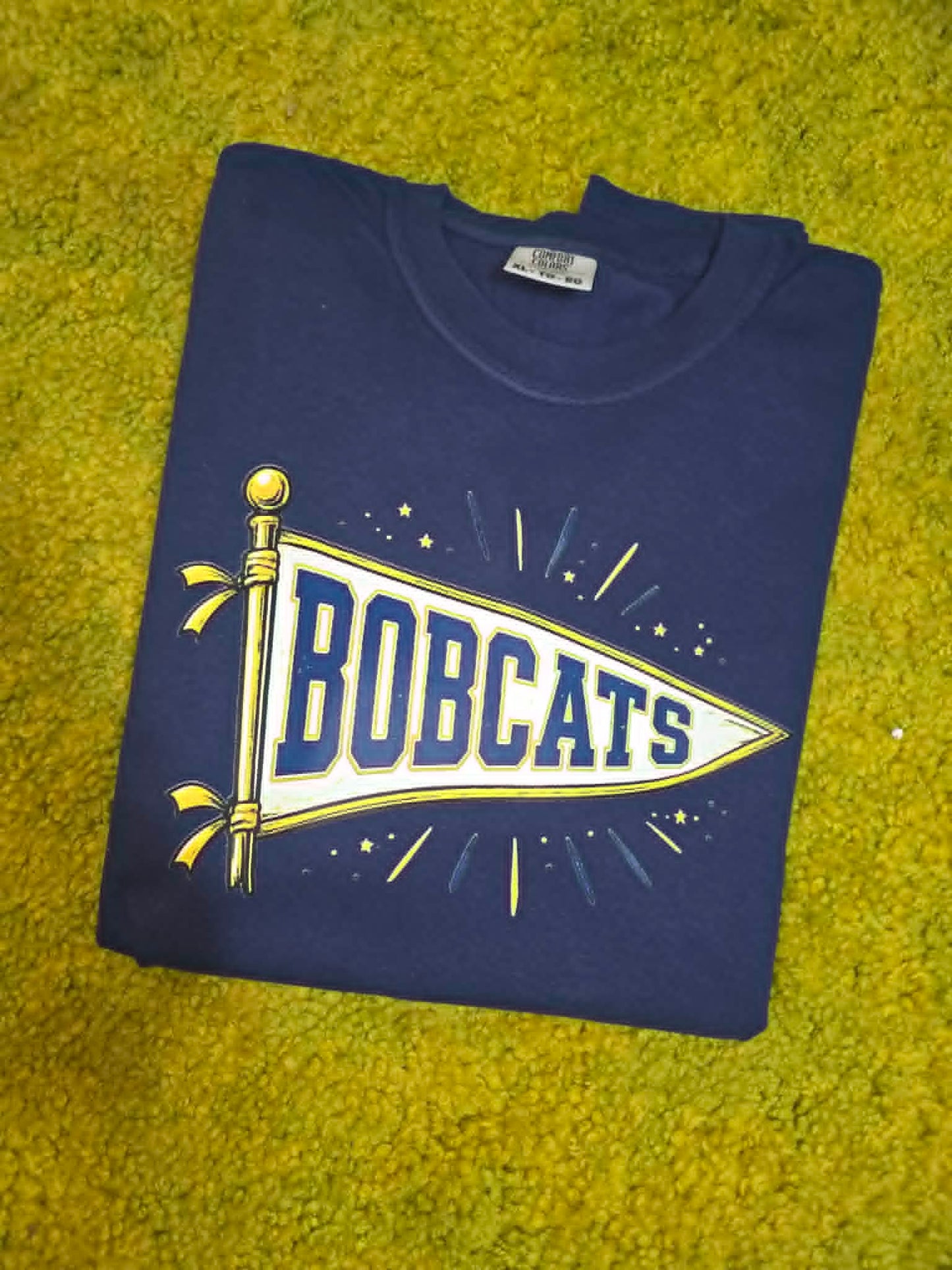 Navy Bobcats shirt with white, blue, and gold school pennant graphic