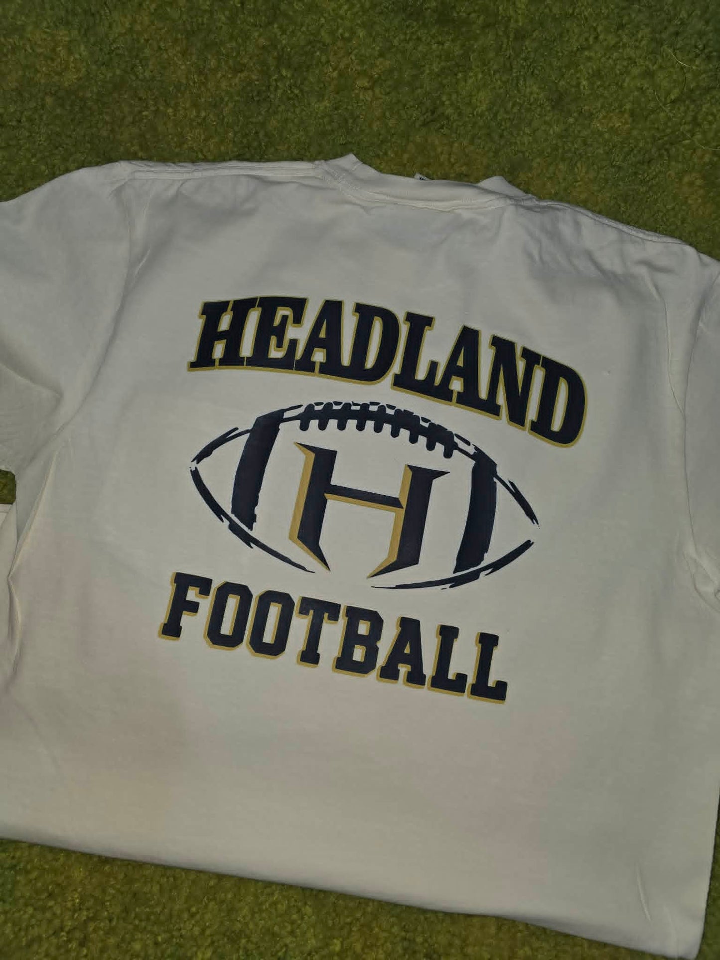 White Headland football shirt with navy and gold lettering and H logo