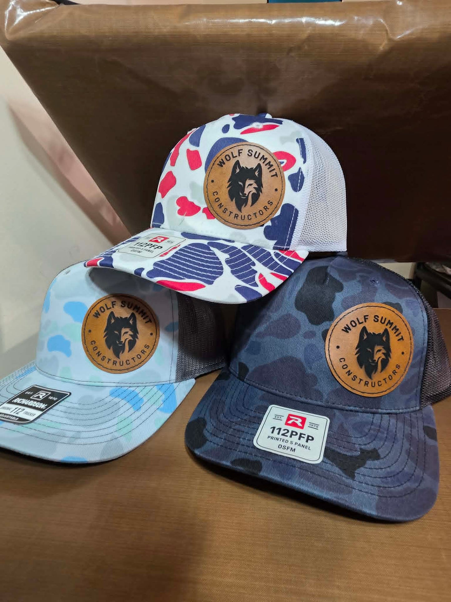 Patterned and camouflage mesh hats with round Wolf Summit Constructors leather patches