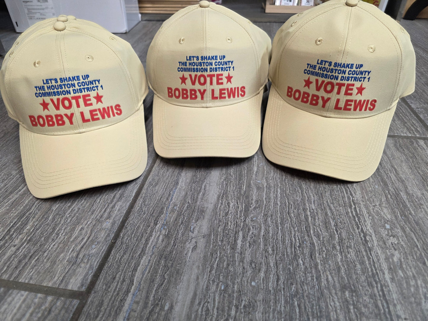Tan campaign hats embroidered with Vote Bobby Lewis for Houston County Commission District 1