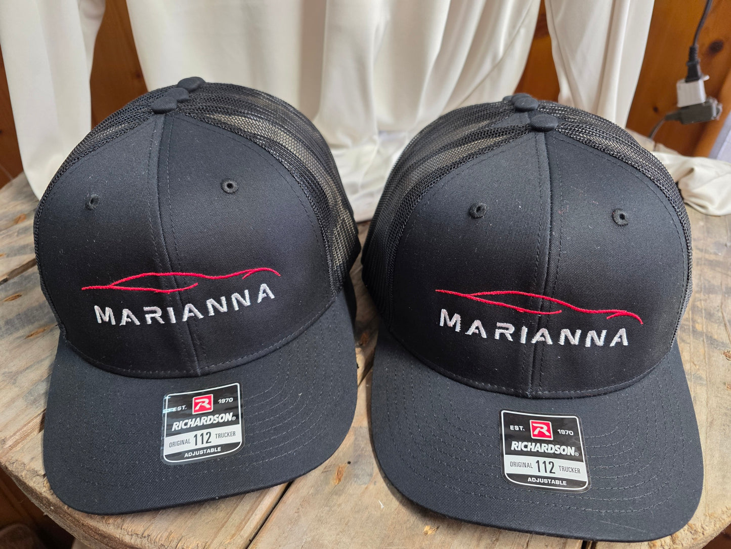 Black Richardson trucker hats embroidered with the Marianna automotive logo