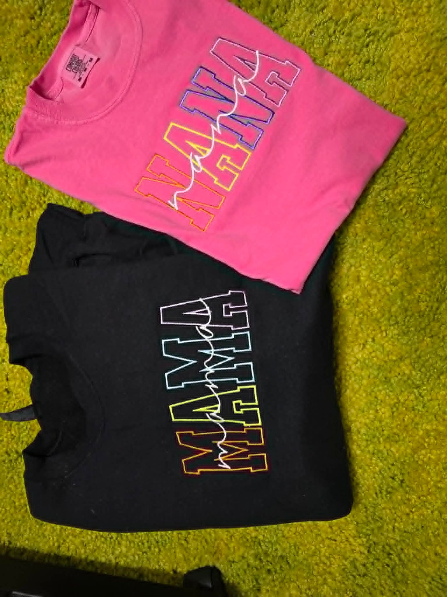 Pink and black Alabama Mama shirts with multicolor outlined varsity lettering