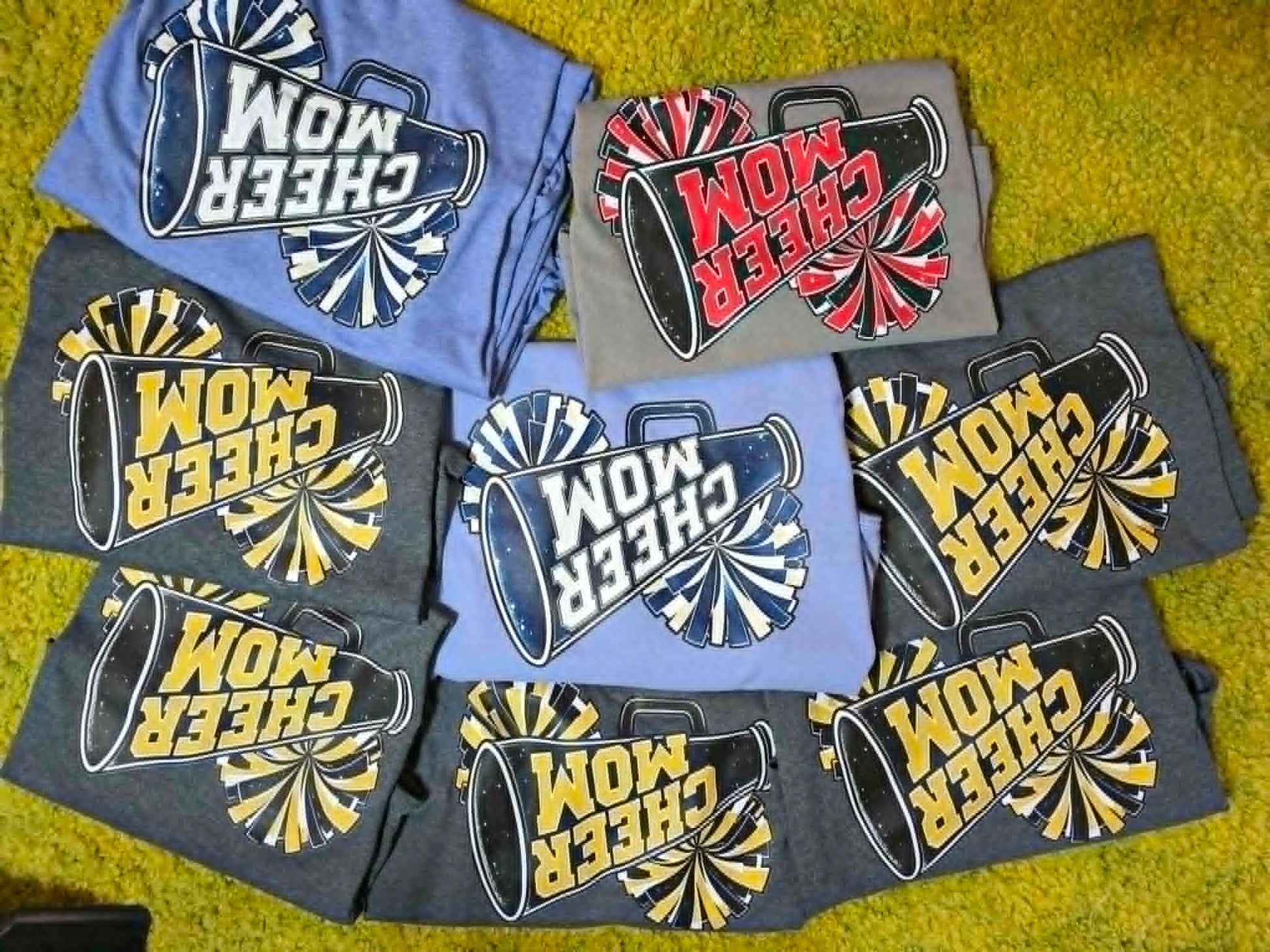 Cheer Mom shirts with megaphones and pom-poms in multiple school colors
