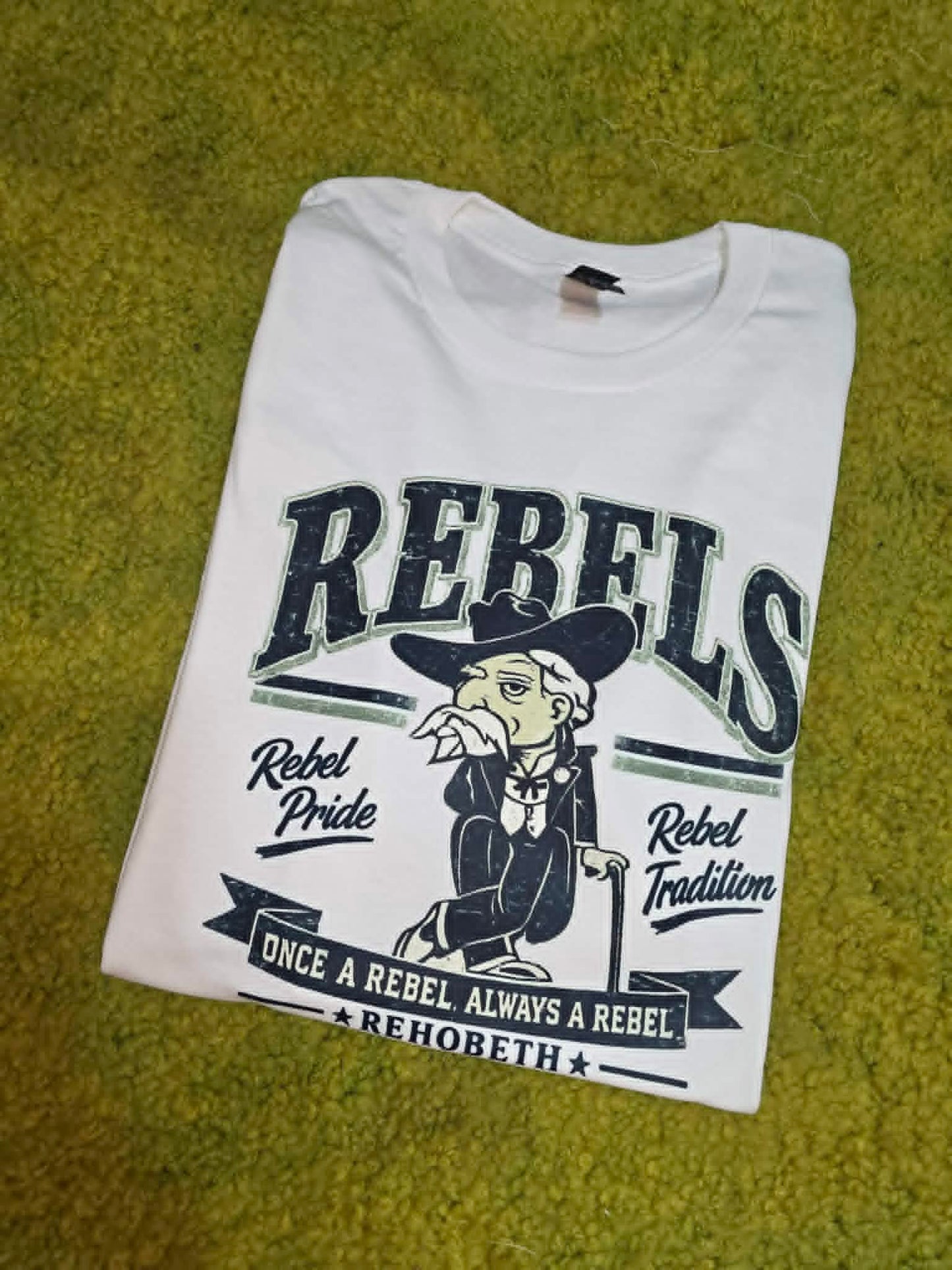 White Rehobeth Rebels shirt with mascot and Rebel Pride Rebel Tradition wording