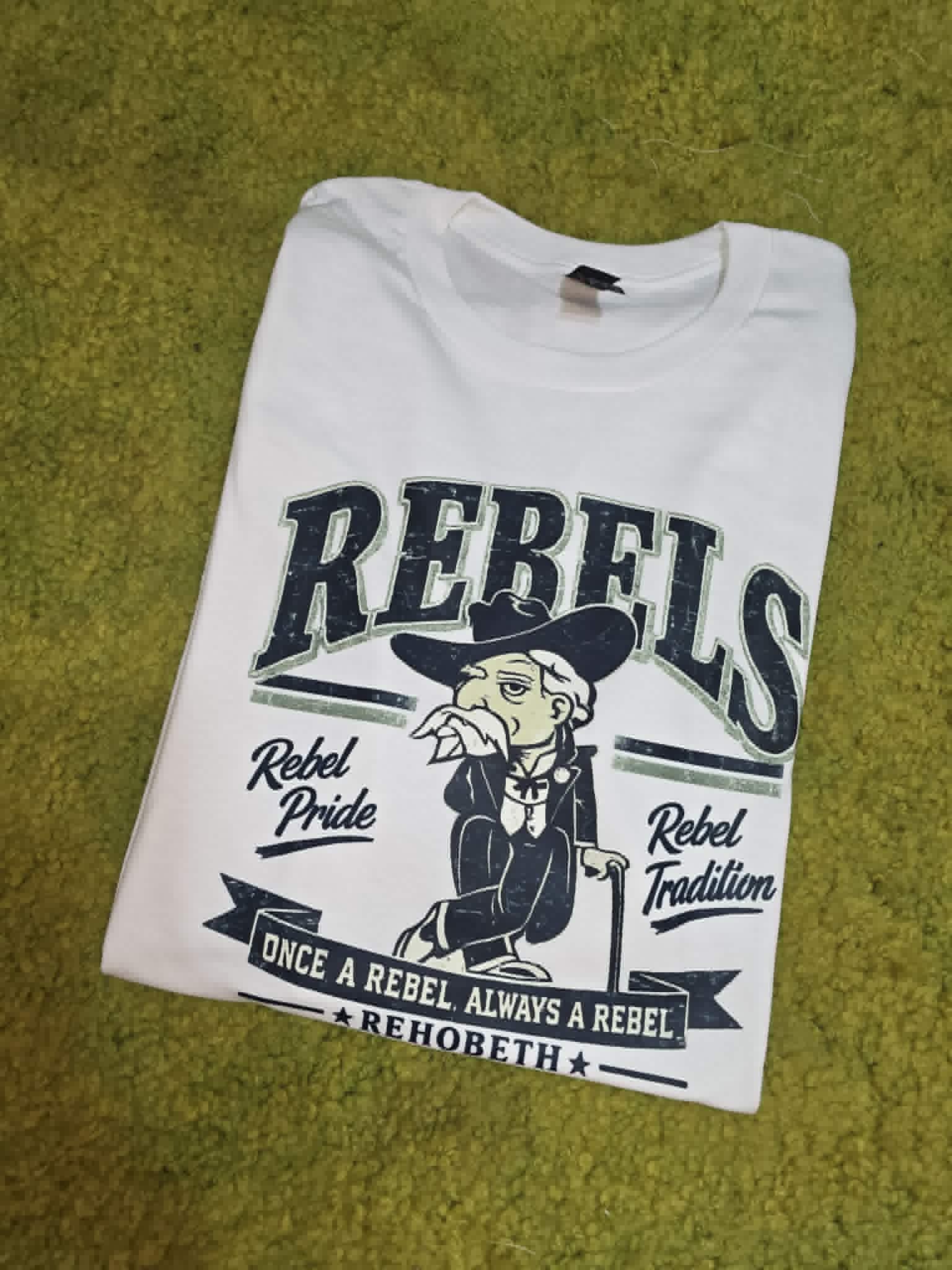 White Rehobeth Rebels shirt with mascot and Rebel Pride Rebel Tradition wording