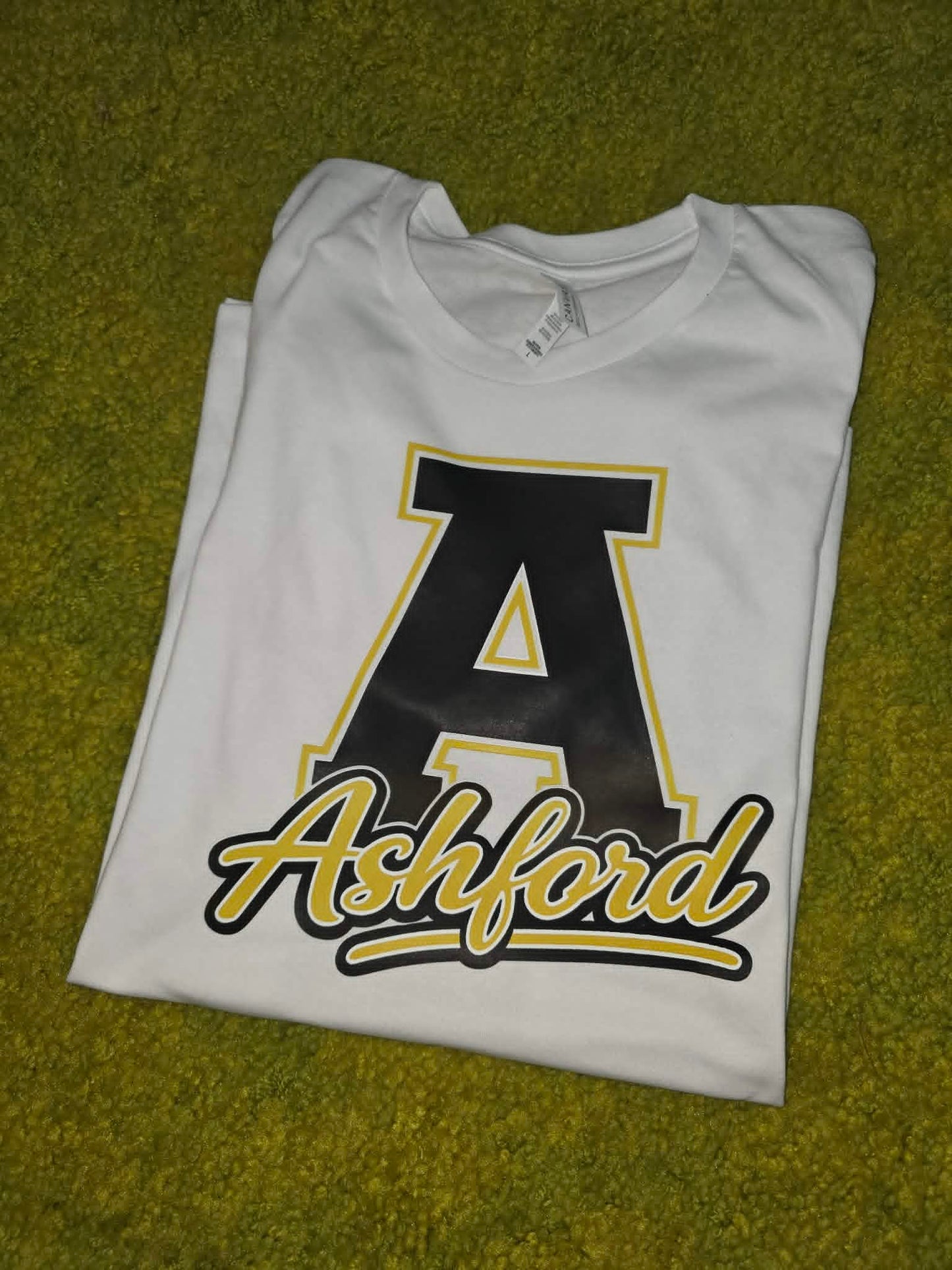 White Ashford shirt with large black and gold varsity letter A