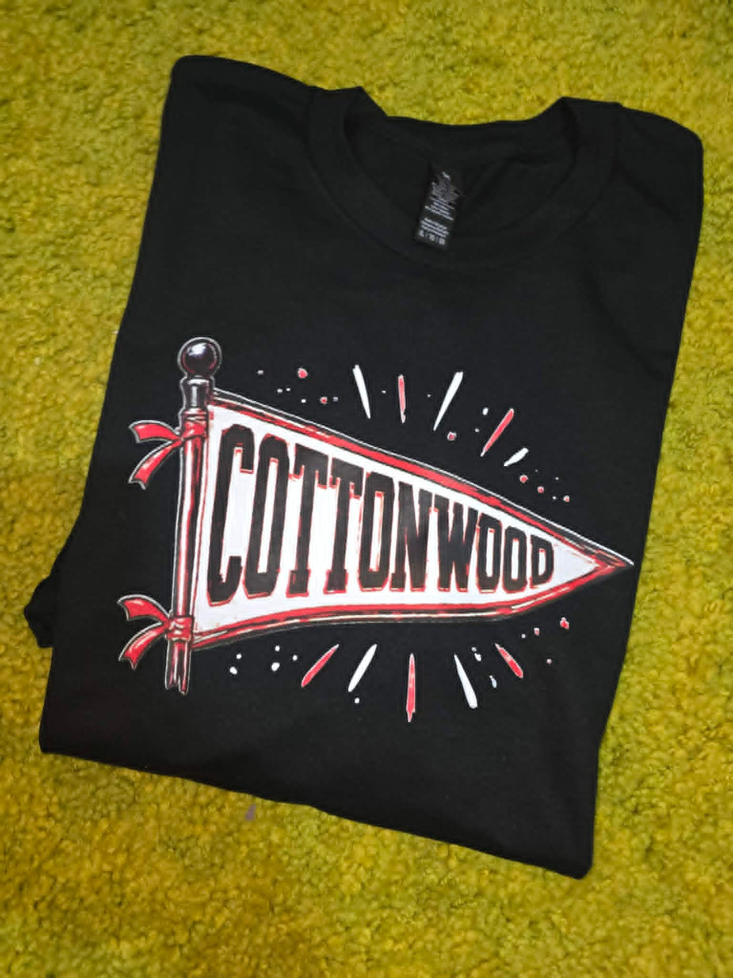 Black Cottonwood school spirit shirt with red and white pennant graphic