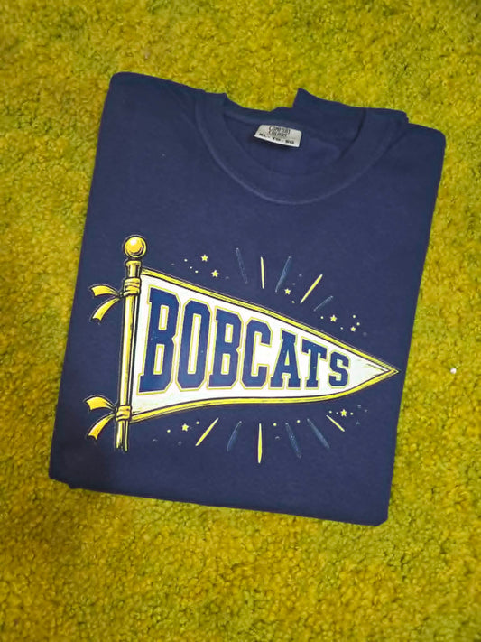 Navy Bobcats shirt with white, blue, and gold school pennant graphic