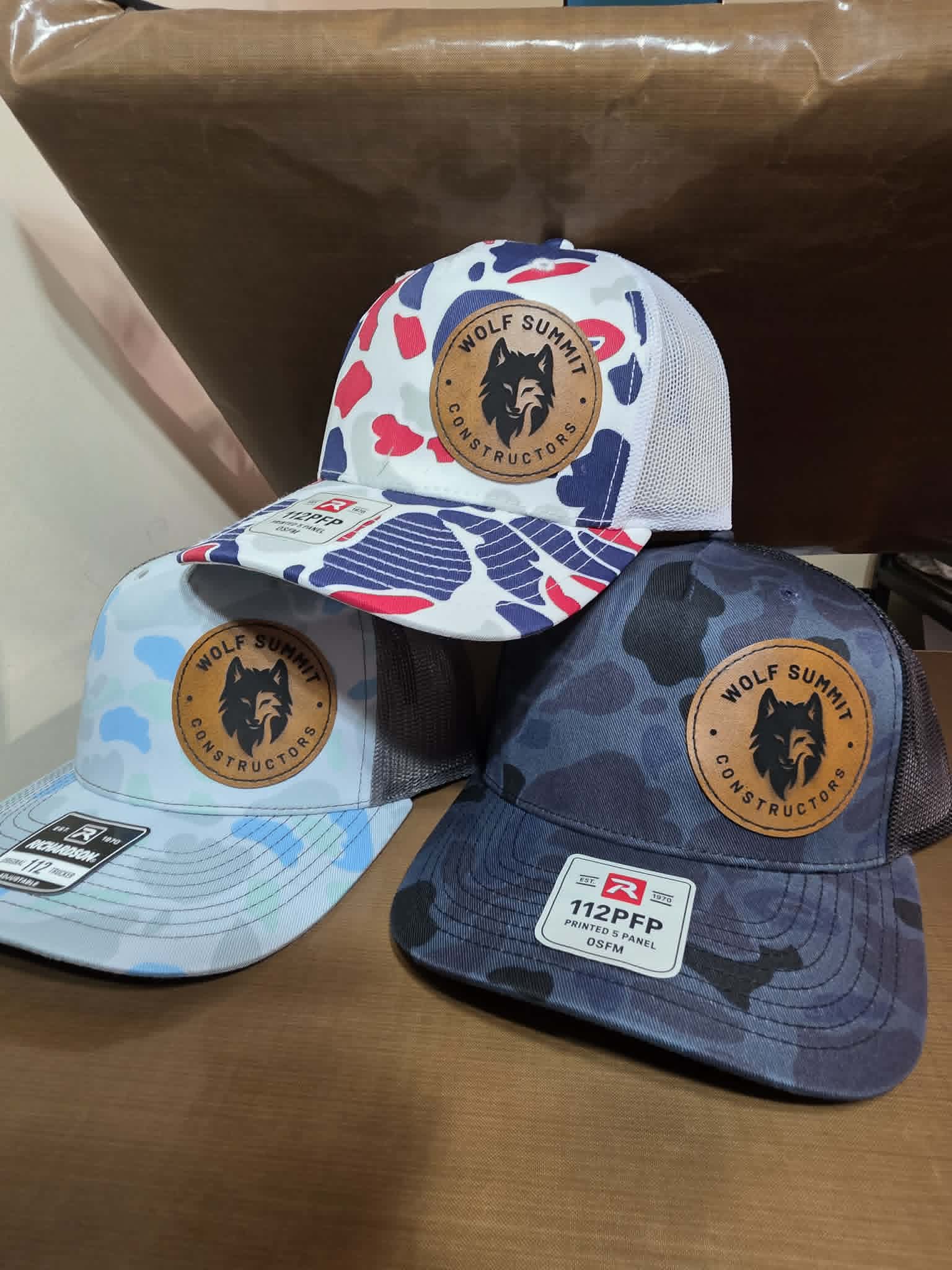 Patterned and camouflage mesh hats with round Wolf Summit Constructors leather patches