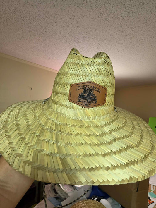 Straw sun hat with a Boots to Grass Lawn Care leather logo patch