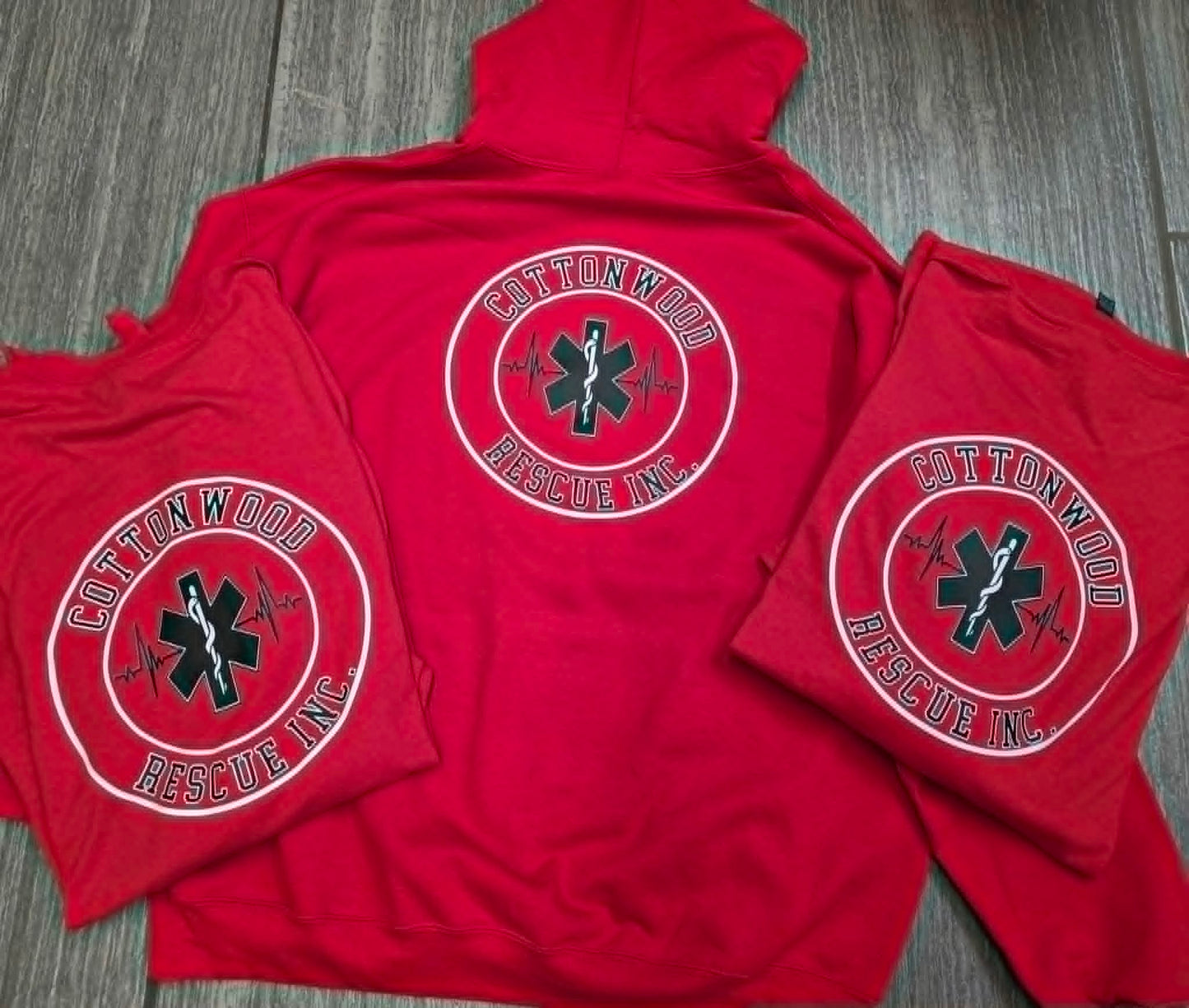 Red Cottonwood Rescue apparel with a circular emergency medical logo