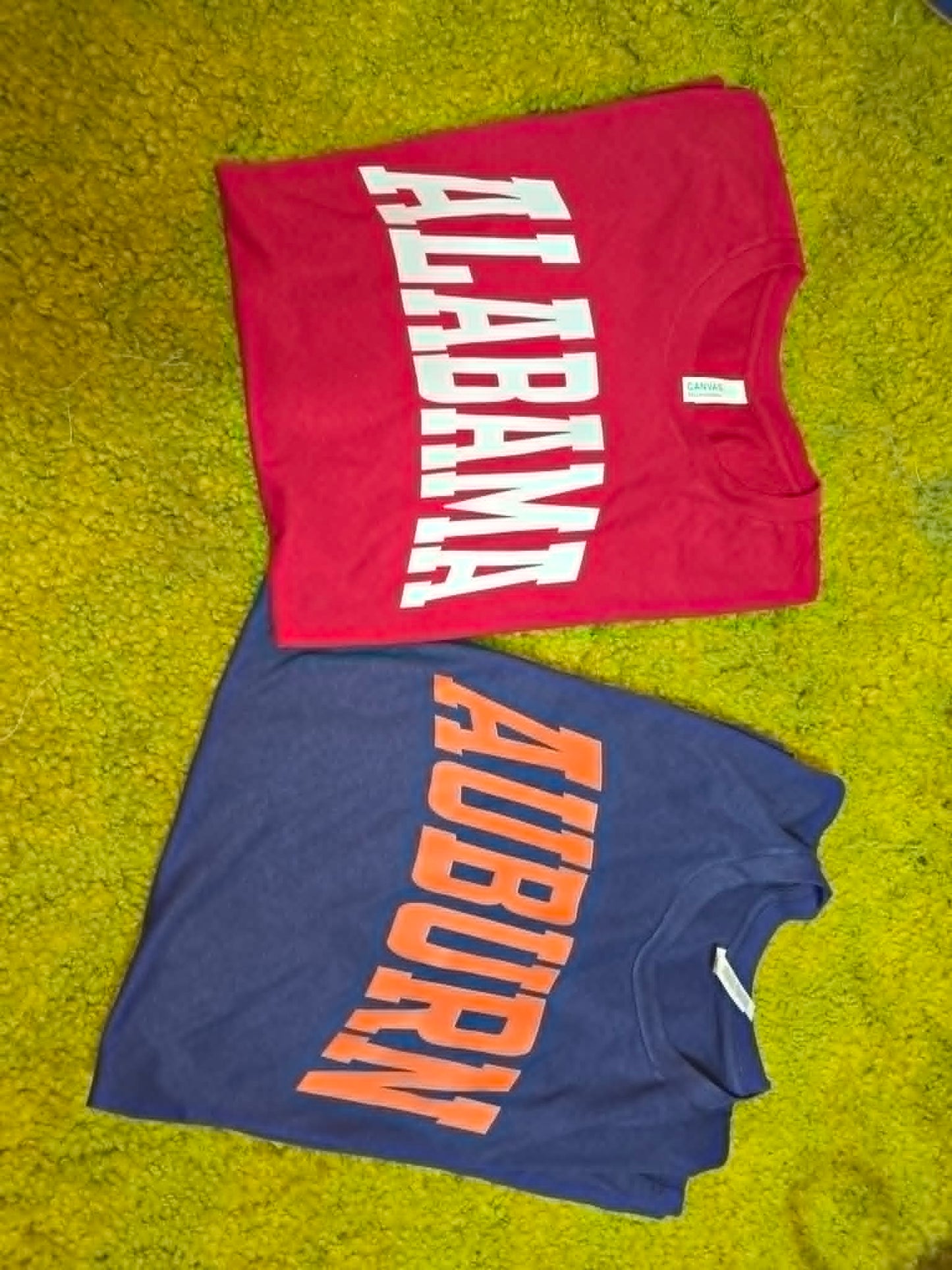 Red Alabama and navy Auburn school spirit shirts with bold split lettering