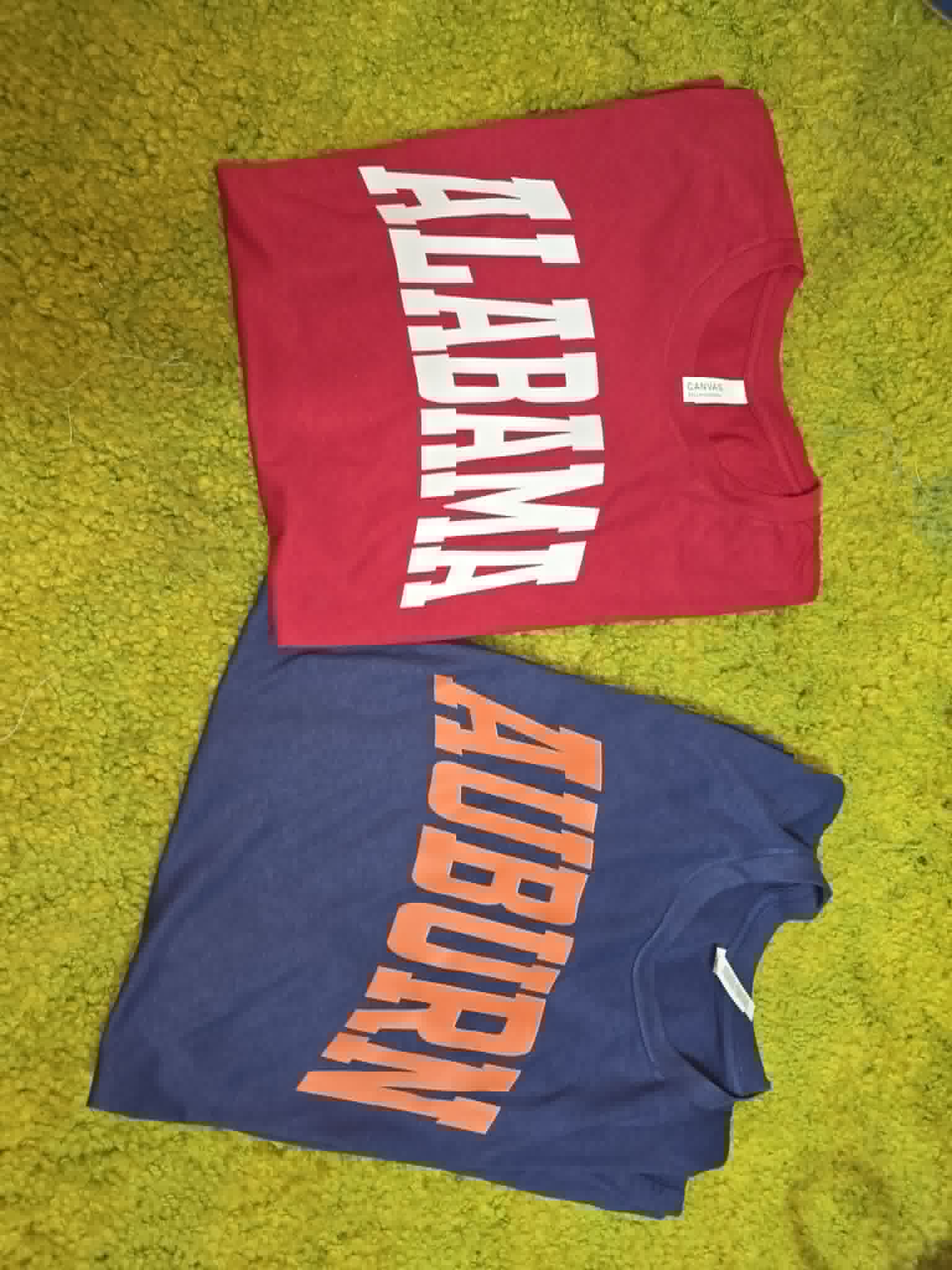 Red Alabama and navy Auburn school spirit shirts with bold split lettering